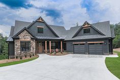 a large gray house with two garages