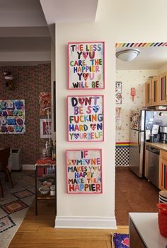 three framed pictures hanging on the wall in a kitchen