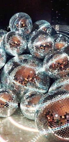 many shiny disco balls are stacked on top of each other