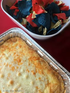 a casserole dish with tortilla chips in it and a bowl of nachos on the side