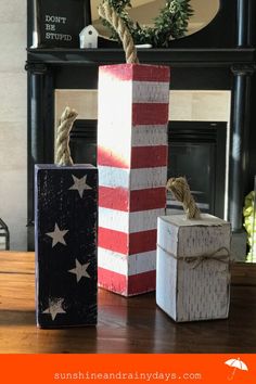 three wooden boxes with rope tied to them sitting on a table in front of a fireplace