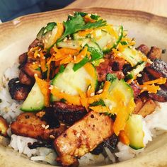 a bowl filled with rice, meat and vegetables