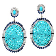 Cast from 18-karat gold and sterling silver. These earrings are set in 45.05 carats turquoise, 4.41 carats blue sapphire and 2.17-carats of diamonds. FOLLOW MEGHNA JEWELS storefront to view the latest collection & exclusive pieces. Meghna Jewels is proudly rated as a Top Seller on 1stDibs with 5 star customer reviews. All items manufactured by us are handmade and can be customized or redesigned. Size-62X33MM Total Weight-27.93 Gold Weight(Gms)-1.7 Silver Weight(Gms)-15.804 Diamond Wt(Cts)-2.17 B