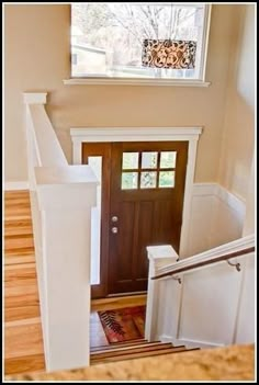 an overhead view of stairs leading up to a door with a window in the background