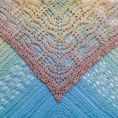 the crocheted shawl is multicolored and has two rows of stitches