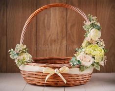 a wicker basket with flowers on the floor