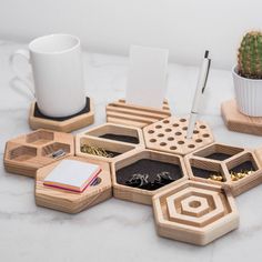 a table topped with wooden trays filled with different types of items next to a cup