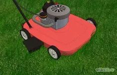 a red lawn mower sitting on top of a lush green field