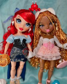 two dolls that are standing next to each other