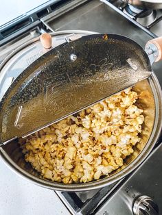 someone is frying some food in a pan on top of the gas burner