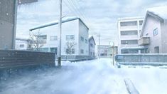 a snow covered street next to some buildings