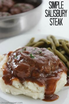 a white plate topped with mashed potatoes covered in gravy