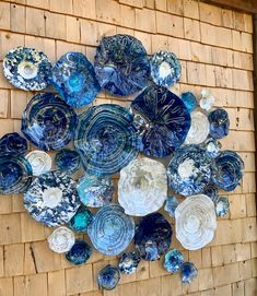 blue and white plates are arranged on a wall