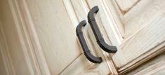 a close up of a door handle on a wooden door