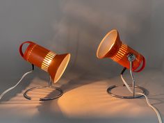 two orange lamps sitting next to each other