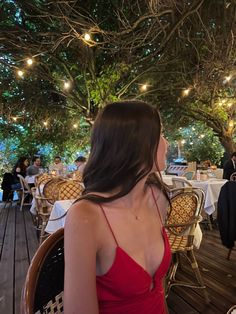 a woman in a red dress sitting at a table