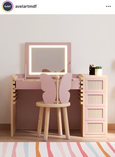 a pink desk with a mirror and chair