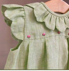 a green dress with pink flowers on it