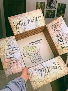 someone is holding up a map with words on it that read, you mean to love the world