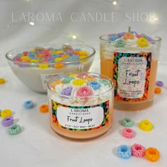 two jars filled with colorful candies next to each other on a white tablecloth