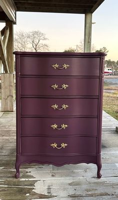 a purple dresser sitting on top of a wooden floor