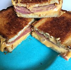 four grilled sandwiches stacked on top of each other with cheese and ham in between them