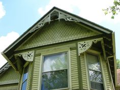 a green house with white trim and windows