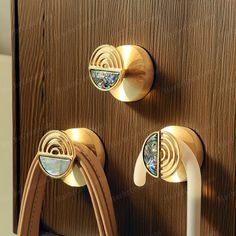 the door handles are gold and have colorful designs on them, as well as two white handles