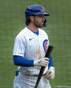 a baseball player holding a bat on top of a field