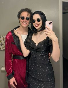 two people taking a selfie in the bathroom