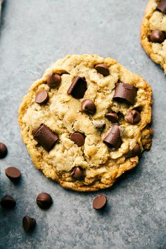 two chocolate chip cookies sitting on top of a table