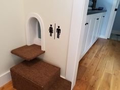 there is a brown carpeted stair case in the bathroom with two men and a woman stickers on the wall