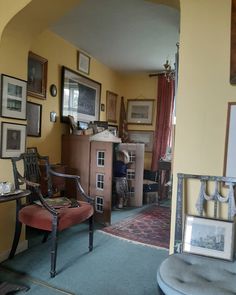 a living room filled with furniture and pictures