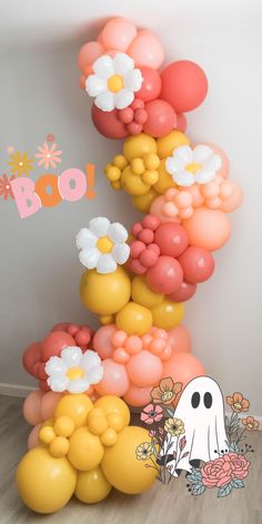 the balloon arch is decorated with flowers and balloons