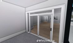 an empty room with white walls and glass doors