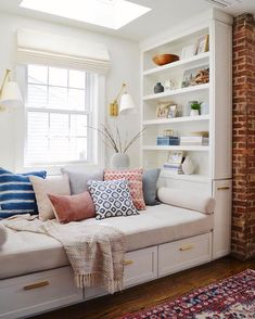 a living room filled with lots of white furniture