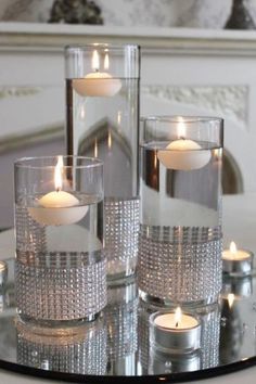 some candles are sitting on a glass table