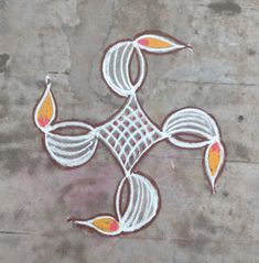 an intricately designed design on the ground with orange and white leaves painted on it