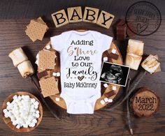 a baby onesuit with marshmallows and graham crackers on the side