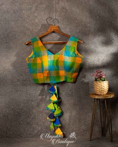 To Go Fabulously With Your Entire Plain Drape'S This Multicoloured Checks V-Neck Blouse Makes A Perfect Pick. The Magically Drafted Yellow-Green-Blue Shaded Latkans At The Back Makes A Chic Statement. Multicolor Unstitched V-neck Blouse, Bohemian V-neck Multicolor Blouse, Cotton Blouse, V Neck Blouse, Cotton Blouses, Blouse Designs, Blue Green, Checks, Saree