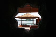 a gazebo sitting on top of a beach next to the ocean