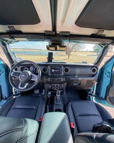 the interior of a vehicle with its dashboard and dash lights on, looking down at the driver's seat