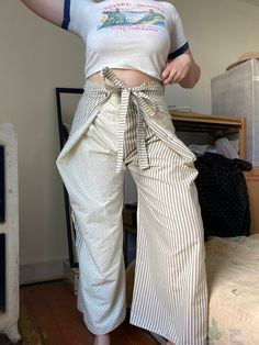 "Unique & one of a kind pants. Only worn a few times. Can be worn fastened in front or back.  Waist: 16 Rise: 16 Hip: flexible depending on desired fit (shown on 42\" hip) Inseam:25.5" Stretch Wide Leg Parachute Pants With Belt Loops, Fitted Wide Leg Harem Pants With Belt Loops, Spring Wide-leg Harem Pants With Belt Loops, Spring Wide Leg Harem Pants With Belt Loops, Wide Leg Harem Pants With Belt Loops For Spring, Stretch Wide-leg Pants With Belt Loops, Fitted High-waisted Parachute Pants With Belt Loops, Fitted High-waisted Pants With Tie Waist, Wide-leg Cotton Harem Pants With Belt Loops