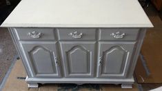 an old dresser is being painted white