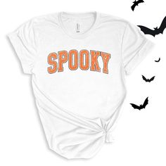 Spooky graphic in a varsity orange and white font. Perfect for this spooky season! Wear to school dress up days, Halloween parties, or just around town for halloween spirit! For All Varsity Spooky T-shirts click here to view.For Adult & Youth Varsity Spooky Sweatshirts click here to view. Adult Sizes S-XXL (unisex sizing)Youth Sizes S-XL (unisex sizing)Toddler Sizes 2T, 3T, 4T (unisex sizing) Bella + Canvas (Adult, Youth & Toddler)4.2 oz. Airlume combed and ring-spun cottonPre-shrunkFor a more relaxed fit, size up! Trendy Fall T-shirt For School, Spooky Orange T-shirt For Fall, Collegiate Fall T-shirt With Lettering, Fall Varsity T-shirt With Lettering, College Fall T-shirt With School Spirit, Trendy School T-shirt For Fall, Varsity Style Fall T-shirt With Letter Print, White T-shirt With Lettering For Fall, Varsity T-shirt With Letter Print For Fall