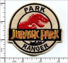 a patch with the words park and a t - rex on it's side