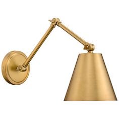 a gold wall light with a white background