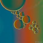 an image of soap bubbles floating in the air on a rainbow colored background with blue, green, red and yellow colors