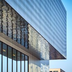 an office building reflecting the sky in its windows