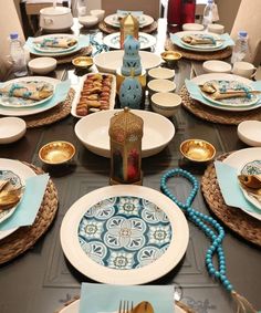 the table is set with plates, silverware, and other decorative items on it